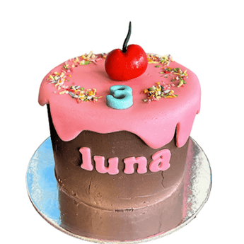 Personalized dog birthday pupcake with pink frosting and cherry for Luna's big day, decorated with sprinkles.