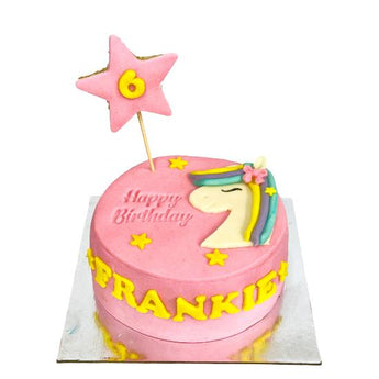 Grain-free dog cake decorated with a unicorn, star, and the name 'Frankie' celebrating a birthday.
