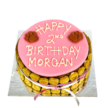 Personalized Happy Birthday wName & Age for a dog's special day, featuring pink frosting and paw prints.