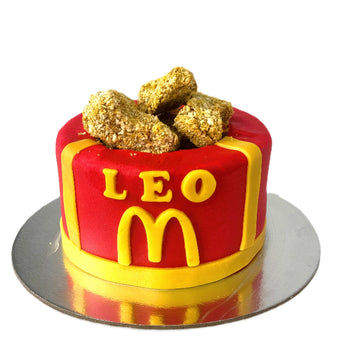 Dog-friendly McNuggets cake for any dog party celebration with colorful icing and delicious treats on top.