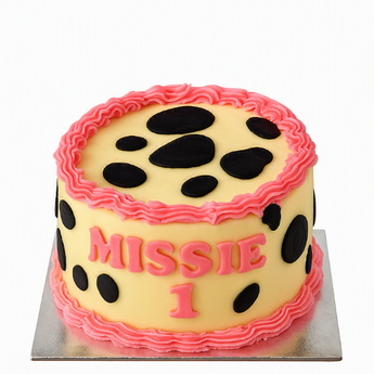 cow print dog birthday cake decorated for a dog named Missie, perfect for any dog party.