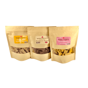 Three packs of homemade dog bone biscuits: Peanut Butter and Coconut Brownie Bites, and Sweet Potato treats.