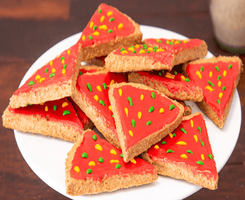 Delicious pizza slice dog treats on a white plate, perfect all-natural handcrafted dog treats for your furry friend.