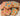 Delicious all-natural paw print dog treats shaped like paw prints with colorful frosting for added fun.